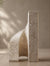 A modern minimalist bookend made of textured travertine marble
