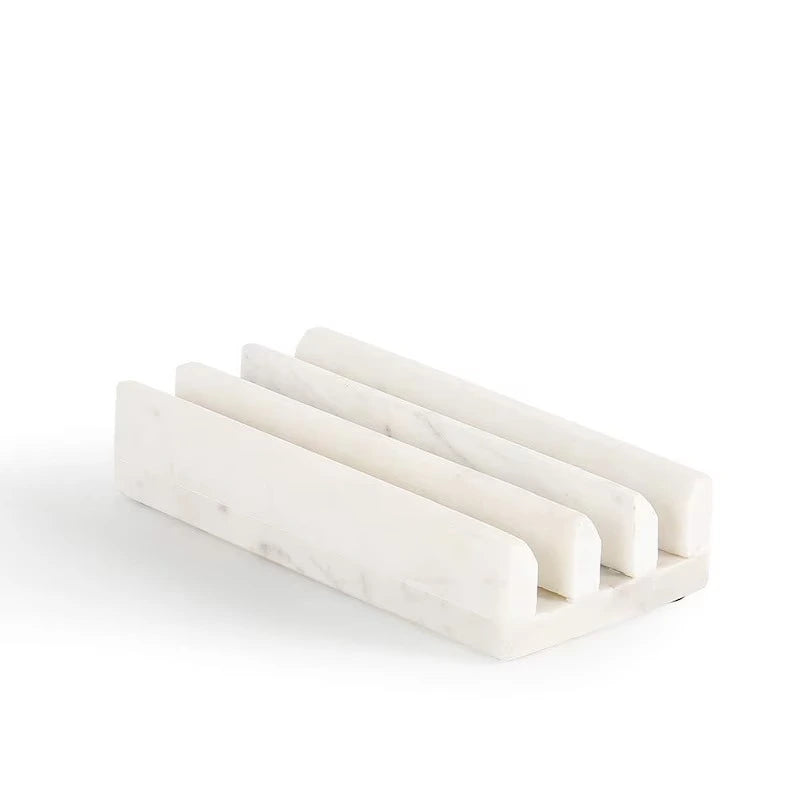 Solid marble multi-slot holder with smooth edges and subtle natural veining.